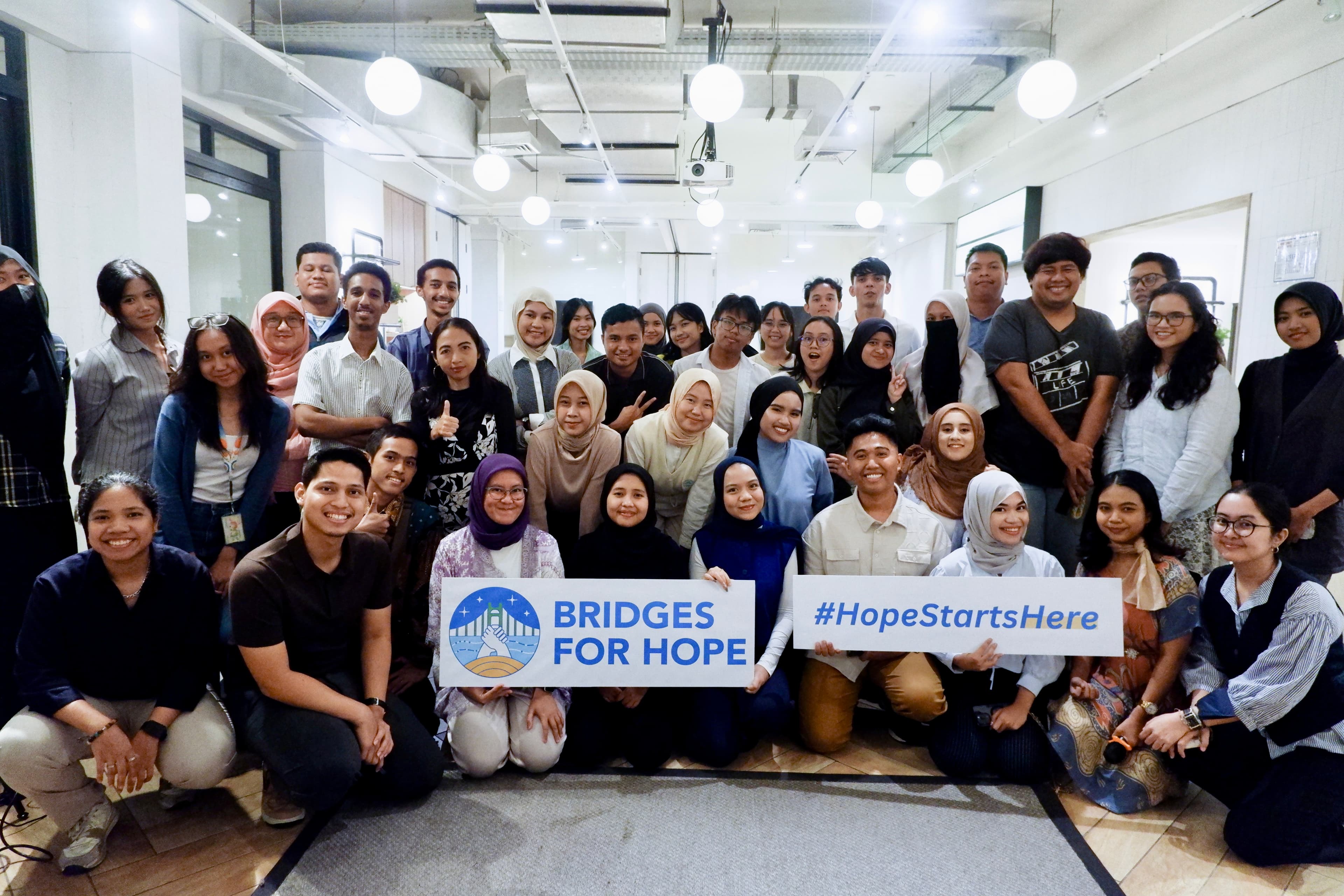 Bridges for Hope community holding a #HopeStartsHere banner